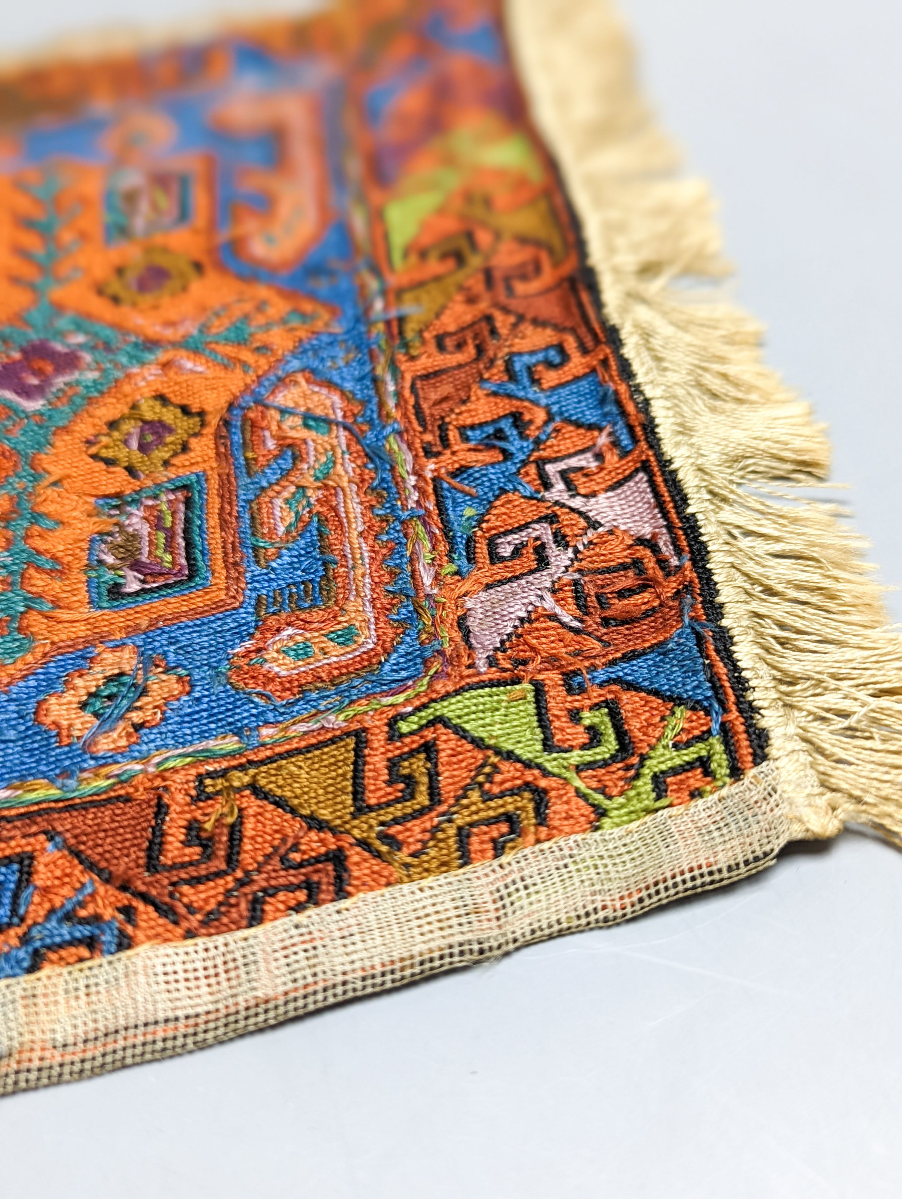 A Caucasian style petit point miniature rug 33x20cm